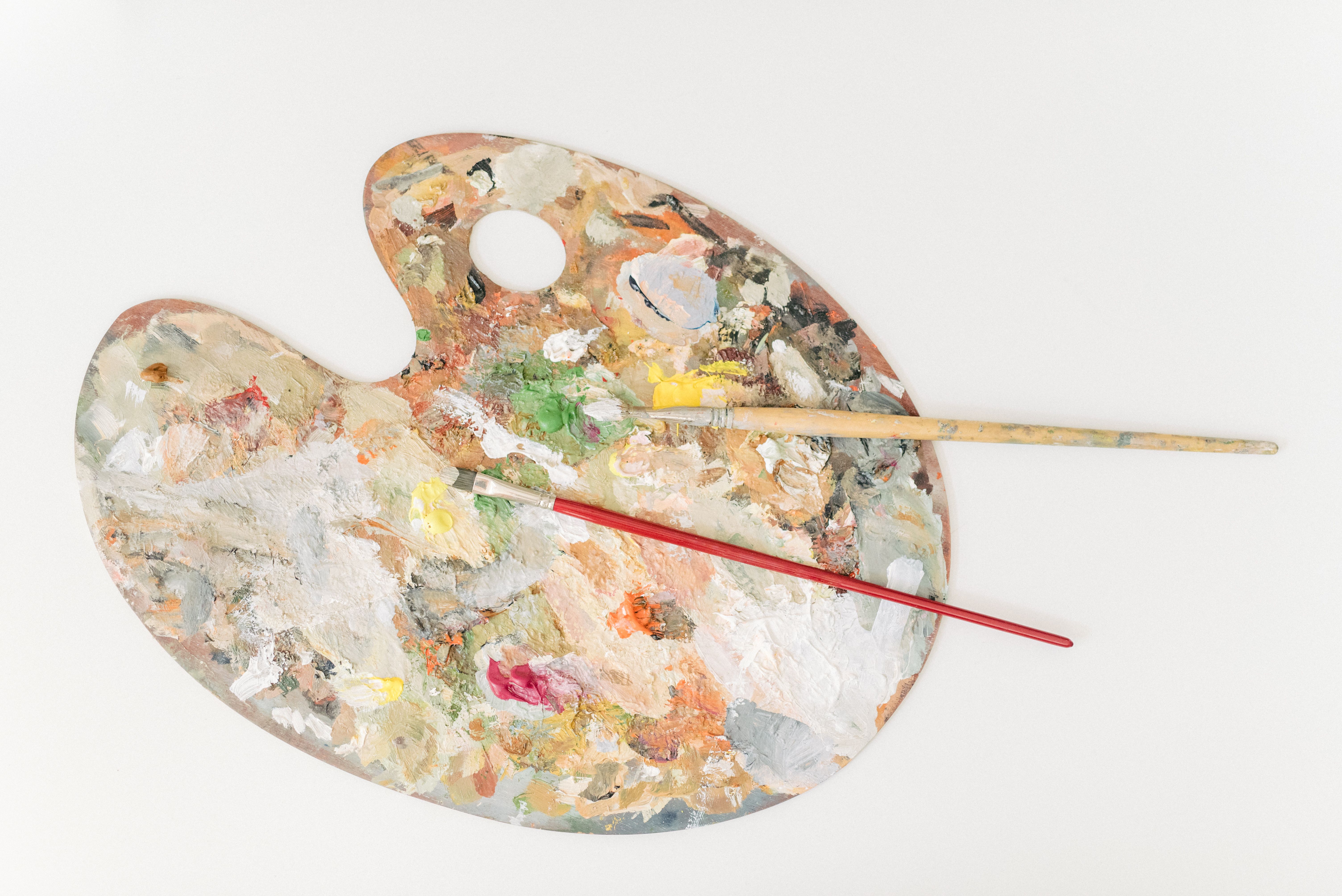 Vibrant artist palette with colorful paint and brushes